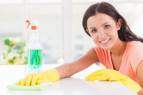 Cleaner in protective gear preparing a safe cleaning area