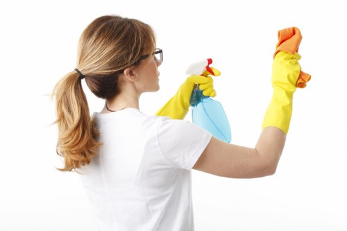 Staff member reviewing safe manual handling practices during cleaning work