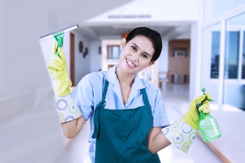 Cleaner wearing protective gloves while using approved cleaning products